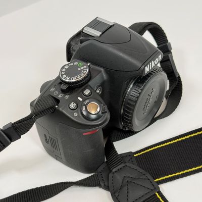 LOT 69A: Nikon D3100 Camera Body w/ Mod Camera Strap (NO BATTERY)