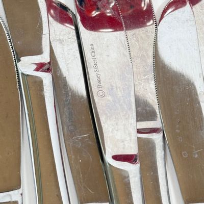 LOT 75A: Disney Mickey & Minnie Mouse Red Mugs (4) & Stainless Steel Mickey Cutout Flatware: 11 Butter Knives, 12 Tablespoons...