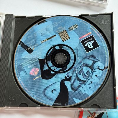 LOT 204V: Sony PlayStation 2 DDR Disney & PS1 Games: Frogger, Crash Bandicoot 2 (holo cover), Soviet Strike, 007 & More