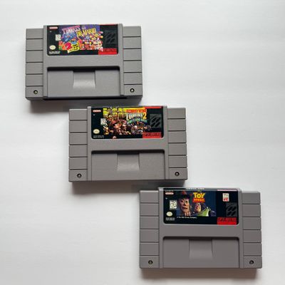 LOT 202V: Vintage Super Nintendo Video Game Cartridges: Tetris & Dr Mario, Donkey Kong Country 2 & Disney's Toy Story
