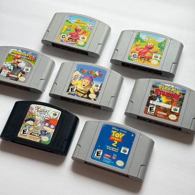 LOT 201V: Vintage Nintendo N64 Video Game Cartridges: Pokémon Stadium, Mario Kart 64, Paper Boy, Toy Story 2, Rugrats in Paris & Elmo...
