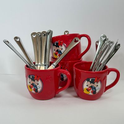LOT 75A: Disney Mickey & Minnie Mouse Red Mugs (4) & Stainless Steel Mickey Cutout Flatware: 11 Butter Knives, 12 Tablespoons...