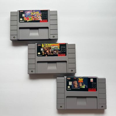 LOT 202V: Vintage Super Nintendo Video Game Cartridges: Tetris & Dr Mario, Donkey Kong Country 2 & Disney's Toy Story