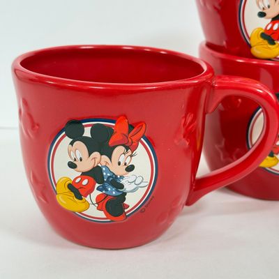LOT 75A: Disney Mickey & Minnie Mouse Red Mugs (4) & Stainless Steel Mickey Cutout Flatware: 11 Butter Knives, 12 Tablespoons...