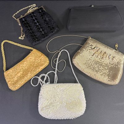 Sale Photo Thumbnail #97: Includes metal mesh, beads, sequins, and more. One bag has a matching coin purse. Total of six pieces. There is age related wear, including some staining on the interior of two of the bags. The largest measures approximately 10” x 5.5”. [CS]