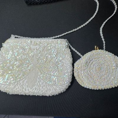Sale Photo Thumbnail #99: Includes metal mesh, beads, sequins, and more. One bag has a matching coin purse. Total of six pieces. There is age related wear, including some staining on the interior of two of the bags. The largest measures approximately 10” x 5.5”. [CS]