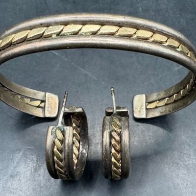 Sale Photo Thumbnail #228: This set includes a cuff bracelet and a pair of earrings. Each piece features gold-filled accents. Each is marked “925, 1/20 GF.” The cuff measures 2.25” wide. The total weight is 23.79 grams. [AG]