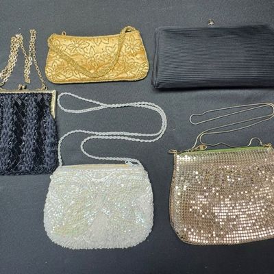 Sale Photo Thumbnail #98: Includes metal mesh, beads, sequins, and more. One bag has a matching coin purse. Total of six pieces. There is age related wear, including some staining on the interior of two of the bags. The largest measures approximately 10” x 5.5”. [CS]