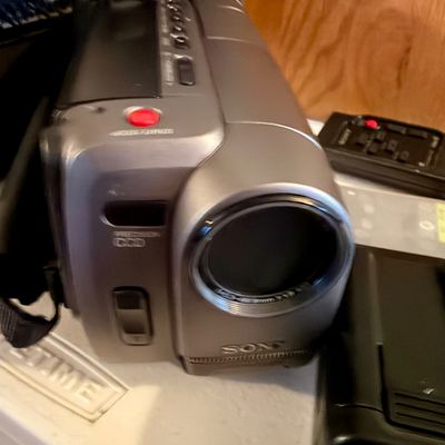 Sale Photo Thumbnail #303: This lot includes a Sony Handycam, tapes, cords, manual and the original carrying case along with a bag of accessories. In good working condition.