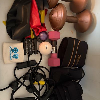 Sale Photo Thumbnail #322: This lot includes hand weights, dumbbells, hand strength grips, stretching bands, and medical wraps.