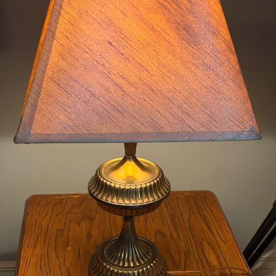 Sale Photo Thumbnail #270: Set of 2 brass lamps. Off white lamp shades. Both in good working order.
