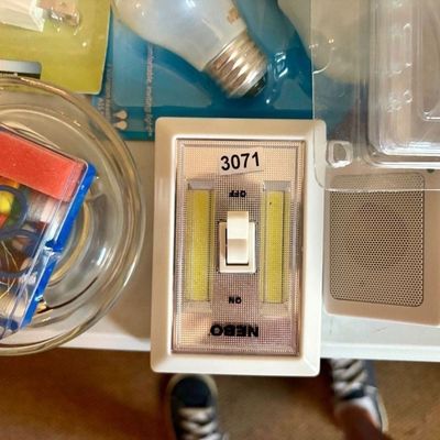 Sale Photo Thumbnail #381: Lot contains many useful household items including light bulbs, nightlights, cans of sealants, etc.