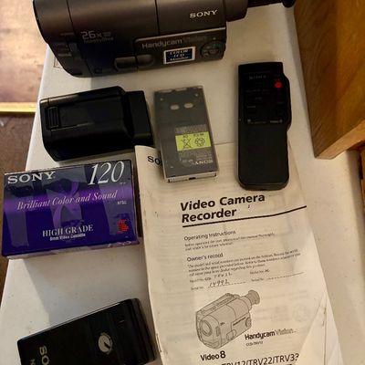 Sale Photo Thumbnail #302: This lot includes a Sony Handycam, tapes, cords, manual and the original carrying case along with a bag of accessories. In good working condition.
