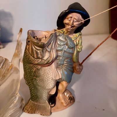 Sale Photo Thumbnail #422: Lot includes the following two items , Large and heavy glass bass and fisherman statue.