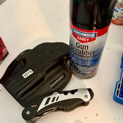 Sale Photo Thumbnail #377: Lot of 3 items including:
1- Kydex holster in black 
1- Gun Tool accesory 
1- Can of gun scrubber  spray