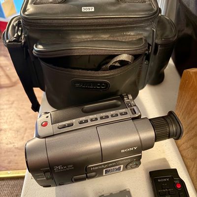 Sale Photo Thumbnail #301: This lot includes a Sony Handycam, tapes, cords, manual and the original carrying case along with a bag of accessories. In good working condition.