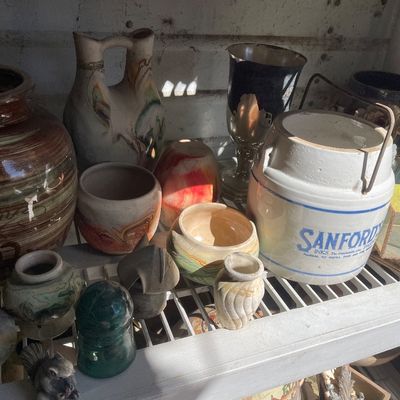 Collection of vintage pottery, stoneware, and glass items, including a white Sanford's Ink stoneware crock, swirling Nemadji-style...