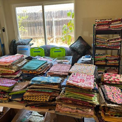 2 tables in the middle of the living room have medium pieces and will let people walk down both sides to look. There’s fabric in bins on...