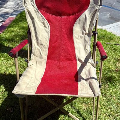 Sale Photo Thumbnail #194: Folding camp chair with cup holder near front of seat.  Good condition, does not have a storage bag.