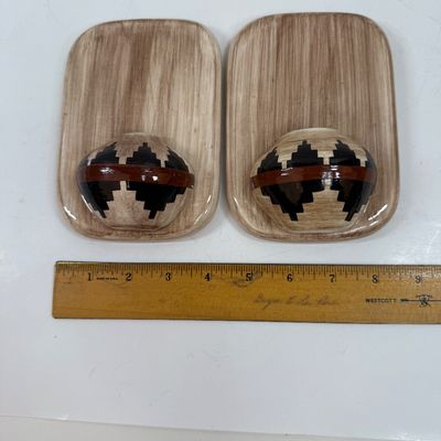Sale Photo Thumbnail #63: Pair of ceramic plaques made to look like a wood plaque with a small woven southwestern basket.  Each is about the size of a standard light switch, good condition.