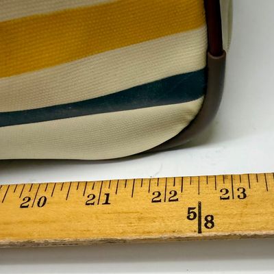 Sale Photo Thumbnail #4: Pendleton Glacier National Park canvas travel bag featuring an ivory body accented with burgundy trim and the iconic multi-color Glacier stripe pattern. Has a telescopic handle and wheels for ease of use. Like-new condition, looks to be sized for carry-on