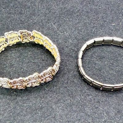 Sale Photo Thumbnail #90: One bracelet made from Liked squares with a stamped butterfly design, the other is a smooth linked set of squares marked "Porodiuti", an stainless steel charm bracelet made in Florence, Italy. Both in good condition.