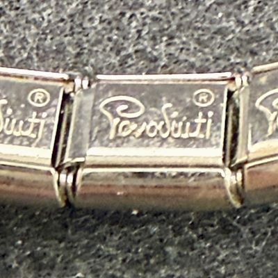 Sale Photo Thumbnail #93: One bracelet made from Liked squares with a stamped butterfly design, the other is a smooth linked set of squares marked "Porodiuti", an stainless steel charm bracelet made in Florence, Italy. Both in good condition.