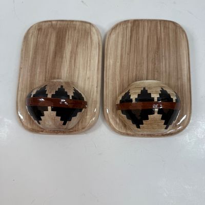 Sale Photo Thumbnail #60: Pair of ceramic plaques made to look like a wood plaque with a small woven southwestern basket.  Each is about the size of a standard light switch, good condition.