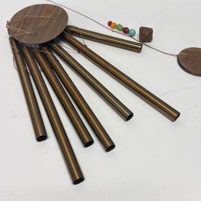 Sale Photo Thumbnail #268: Copper tubes and a central cord holding colored beads and a wood striker.  All parts included except 2 of the colored stones are missing. Wind chime needs the chime tube hanging cords and central chime striker cord reattached. Last photo shows a properly 