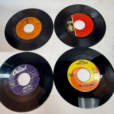Sale Photo Thumbnail #423: The rack is in very good condition, the case is in fair condition with lots of writing, and the records range in condition from poor to good condition. Also 3 spindle spacers included.
