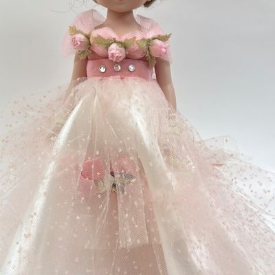 Sale Photo Thumbnail #490: Vintage Robert Tonner Betsy McCall Commemorative Stamp Doll from 1997, dressed in a pink tulle and satin gown with floral accents