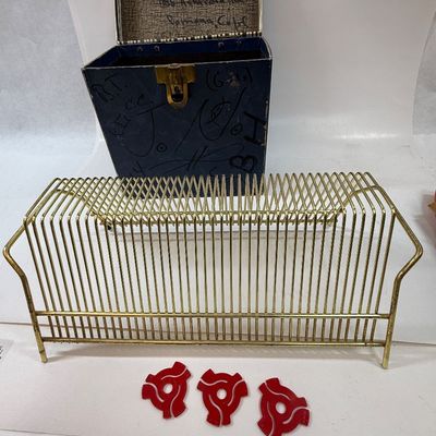 Sale Photo Thumbnail #412: The rack is in very good condition, the case is in fair condition with lots of writing, and the records range in condition from poor to good condition. Also 3 spindle spacers included.