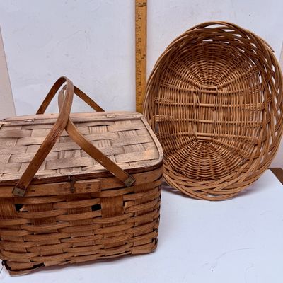 Sale Photo Thumbnail #13: The picnic basket appears to be very old. Has a hinged lid, and a small platform inside with 4 legs, remnant of pale pink paint on the lid. The oval one is in very good condition.