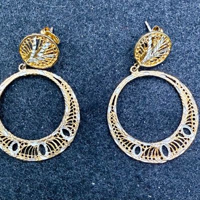 Sale Photo Thumbnail #66: Silver earring marked (M) STERLING, also has areas with a shiny gold-colored tone.  Good condition.