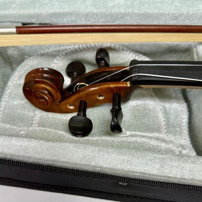 Sale Photo Thumbnail #19: Violin needs to be re-strung, but it otherwise is in near-new condition. Violin and bow both store inside the lined case. See photos for other details.