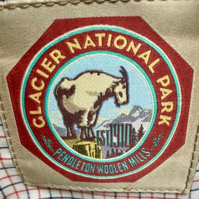 Sale Photo Thumbnail #11: Pendleton Glacier National Park canvas travel bag featuring an ivory body accented with burgundy trim and the iconic multi-color Glacier stripe pattern. Has a telescopic handle and wheels for ease of use. Like-new condition, looks to be sized for carry-on