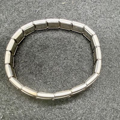 Sale Photo Thumbnail #92: One bracelet made from Liked squares with a stamped butterfly design, the other is a smooth linked set of squares marked "Porodiuti", an stainless steel charm bracelet made in Florence, Italy. Both in good condition.