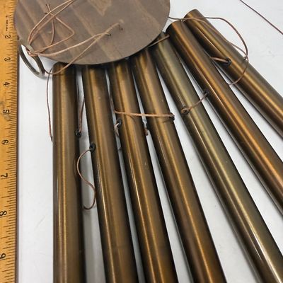 Sale Photo Thumbnail #270: Copper tubes and a central cord holding colored beads and a wood striker.  All parts included except 2 of the colored stones are missing. Wind chime needs the chime tube hanging cords and central chime striker cord reattached. Last photo shows a properly 