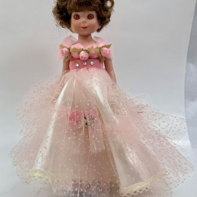 Sale Photo Thumbnail #489: Vintage Robert Tonner Betsy McCall Commemorative Stamp Doll from 1997, dressed in a pink tulle and satin gown with floral accents