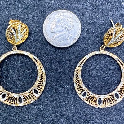 Sale Photo Thumbnail #68: Silver earring marked (M) STERLING, also has areas with a shiny gold-colored tone.  Good condition.
