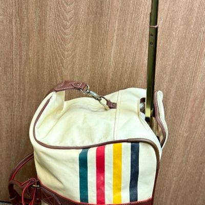 Sale Photo Thumbnail #8: Pendleton Glacier National Park canvas travel bag featuring an ivory body accented with burgundy trim and the iconic multi-color Glacier stripe pattern. Has a telescopic handle and wheels for ease of use. Like-new condition, looks to be sized for carry-on