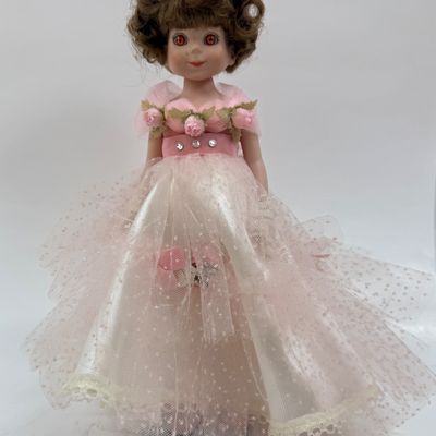 Sale Photo Thumbnail #486: Vintage Robert Tonner Betsy McCall Commemorative Stamp Doll from 1997, dressed in a pink tulle and satin gown with floral accents