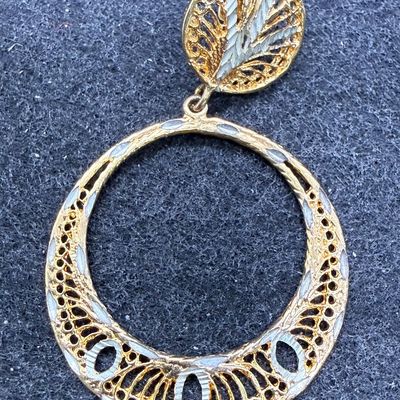 Sale Photo Thumbnail #67: Silver earring marked (M) STERLING, also has areas with a shiny gold-colored tone.  Good condition.