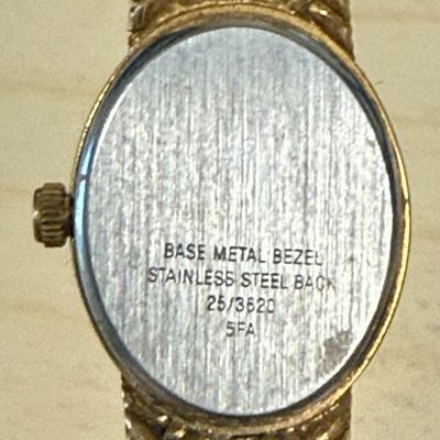 Sale Photo Thumbnail #553: A few scratches in the crystal. Stem pulls out, hands are easily adjusted. Not running, most likely needs a new battery. Model number 25/3620 and reference code 5FA.