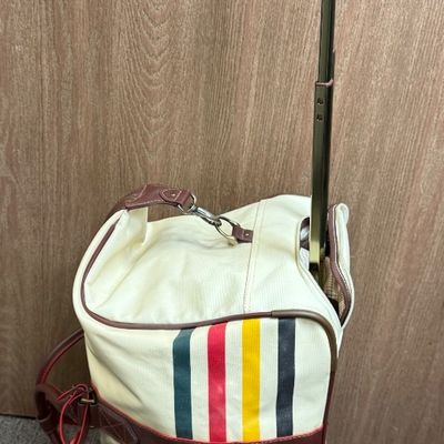 Sale Photo Thumbnail #9: Pendleton Glacier National Park canvas travel bag featuring an ivory body accented with burgundy trim and the iconic multi-color Glacier stripe pattern. Has a telescopic handle and wheels for ease of use. Like-new condition, looks to be sized for carry-on