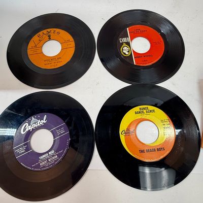 Sale Photo Thumbnail #422: The rack is in very good condition, the case is in fair condition with lots of writing, and the records range in condition from poor to good condition. Also 3 spindle spacers included.