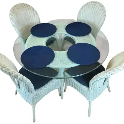 White Wicker Glass-Top Dining Table With Four Chairs and Blue Seat Cushions