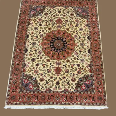 Traditional floral area rug in gold, rust, and burgundy tones