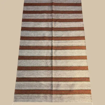 Neutral striped flatweave rug in brown, cream, and rust tones