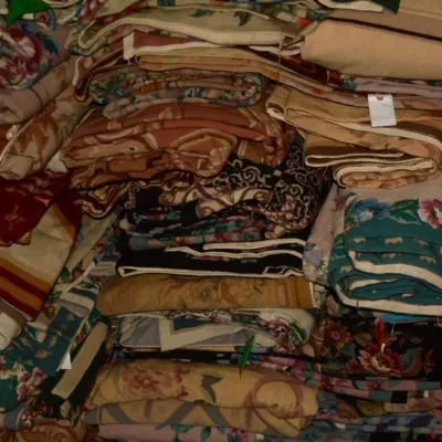 Assorted folded rugs featuring a wide variety of colors and traditional patterns